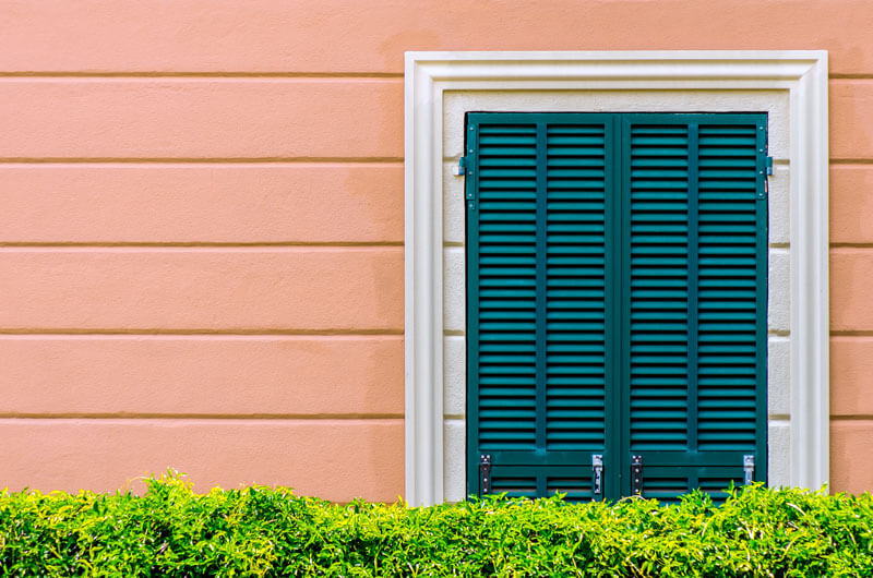 House exterior with green shutter construction material.