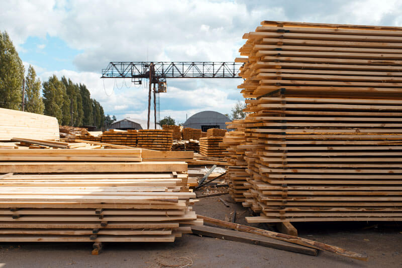 Lumber and building construction materials in a construction yard.